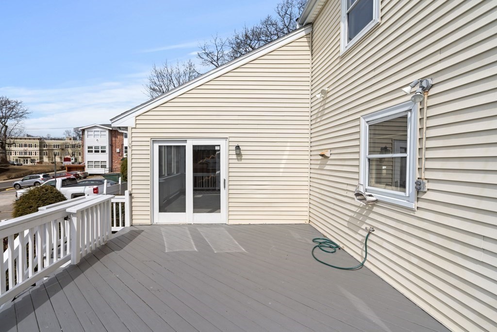 21 Desoto Road Boston, MA 02132 - Photo 36 of 37 a view of a deck with wooden floor and fence and a floor to ceiling window