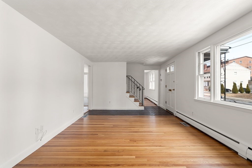 21 Desoto Road Boston, MA 02132 - Photo 4 of 37 a view of an empty room with wooden floor and a window