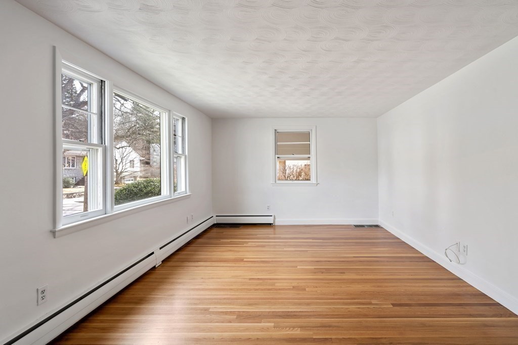 21 Desoto Road Boston, MA 02132 - Photo 5 of 37 a view of an empty room with wooden floor and a window