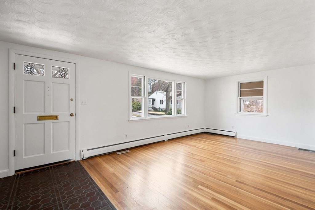 21 Desoto Road Boston, MA 02132 - Photo 6 of 37 an empty room with wooden floor cabinet and windows