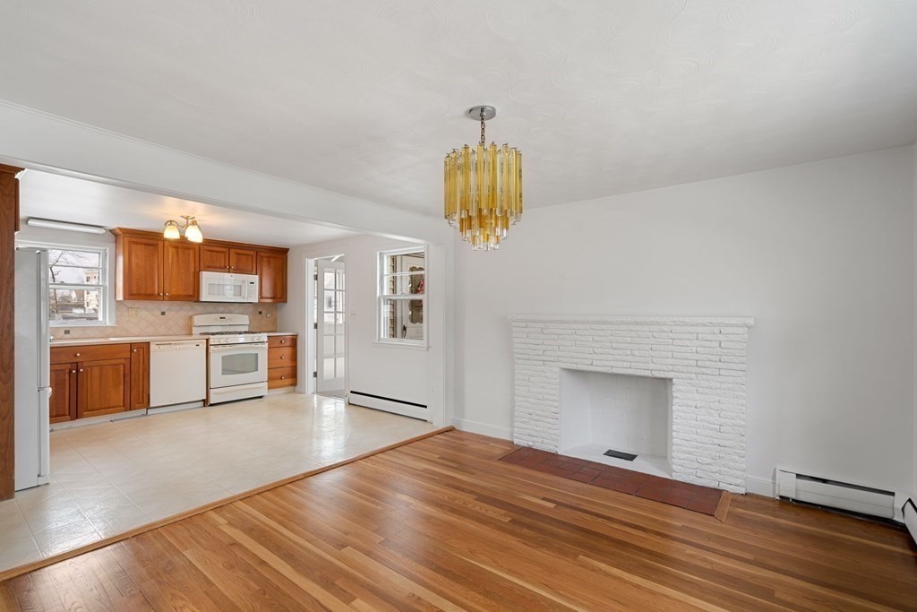 21 Desoto Road Boston, MA 02132 - Photo 10 of 37 a empty room with a fireplace and wooden floor