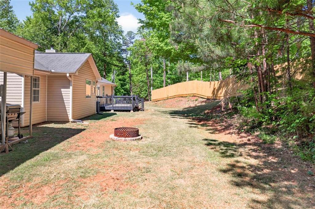 386 Ridgewood Drive Pendergrass, GA 30567 - Photo 37 of 50 a backyard of a house with yard and outdoor seating
