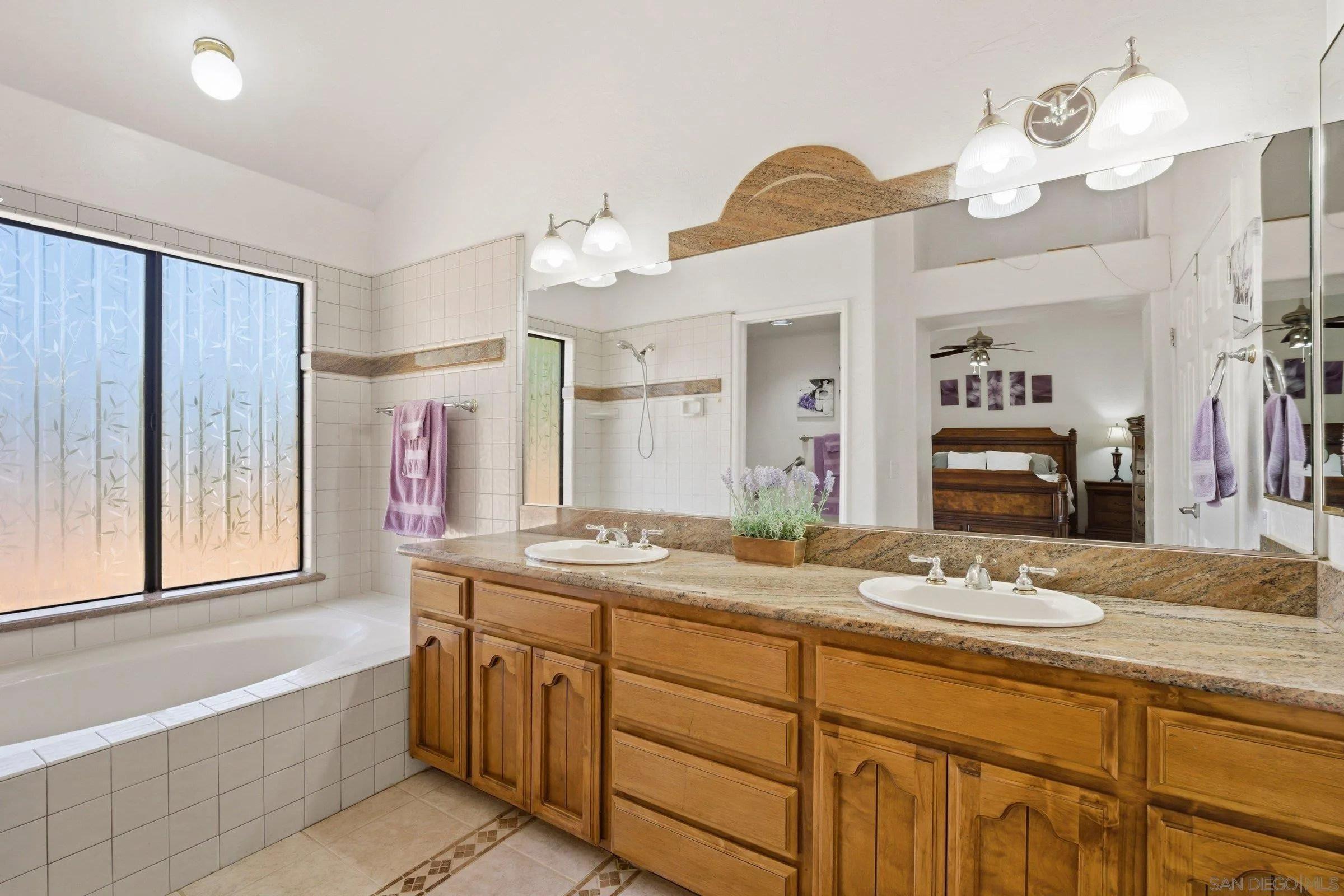 15927 Litten Way Ramona, CA 92065 - Photo 16 of 33 a spacious bathroom with a granite countertop sink a large mirror and a bathtub