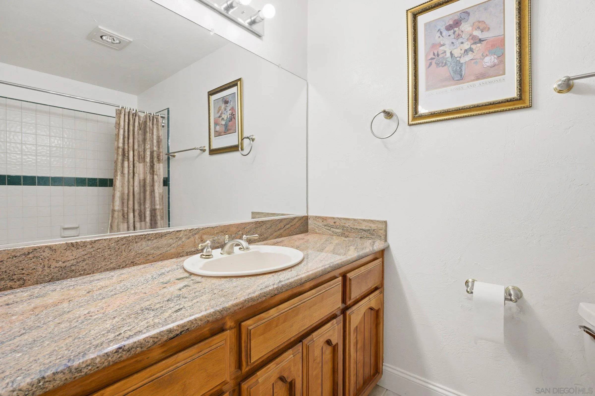 15927 Litten Way Ramona, CA 92065 - Photo 19 of 33 a bathroom with a granite countertop sink and a mirror