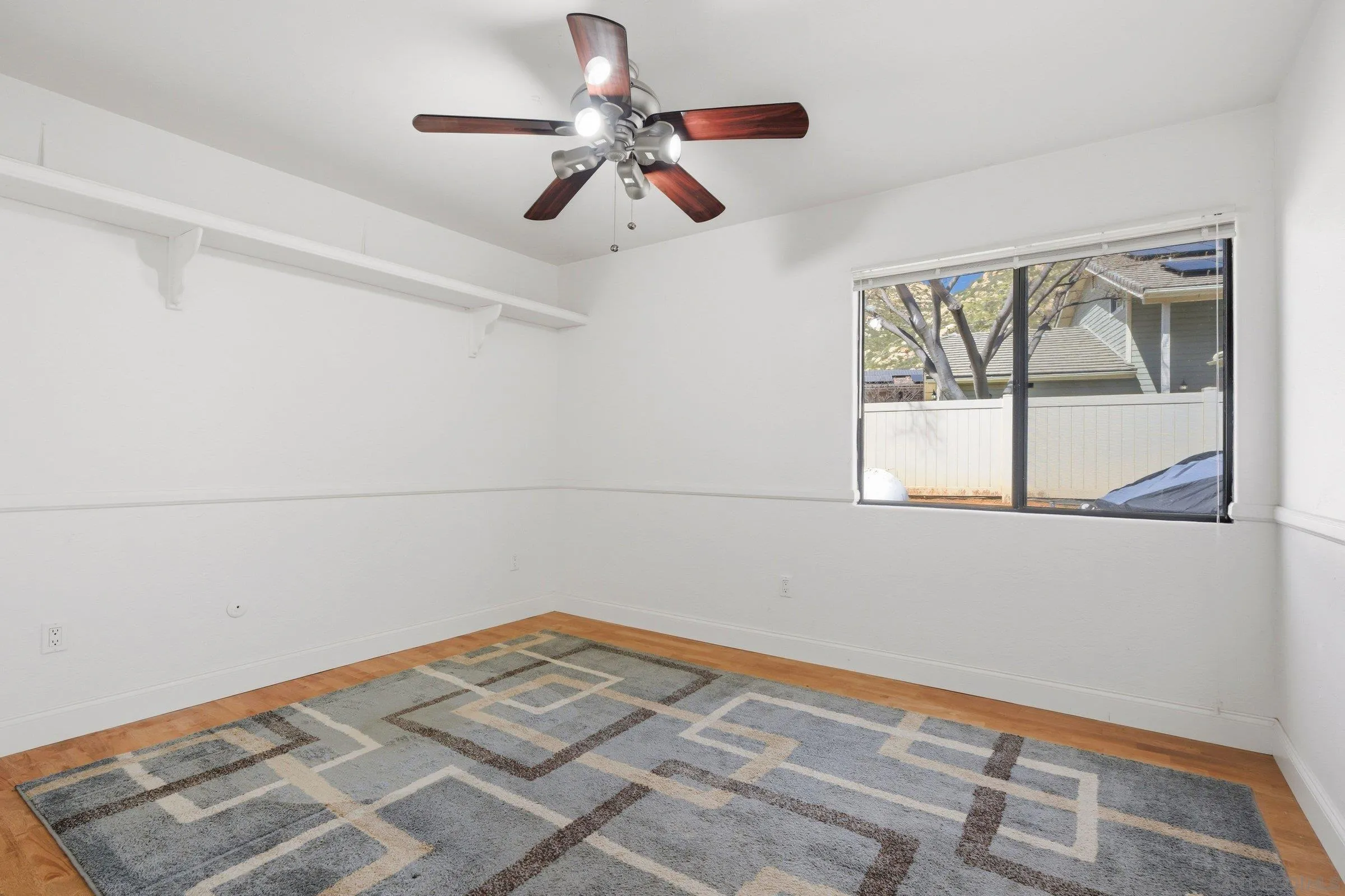 15927 Litten Way Ramona, CA 92065 - Photo 20 of 33 a view of a room with a ceiling fan and a window