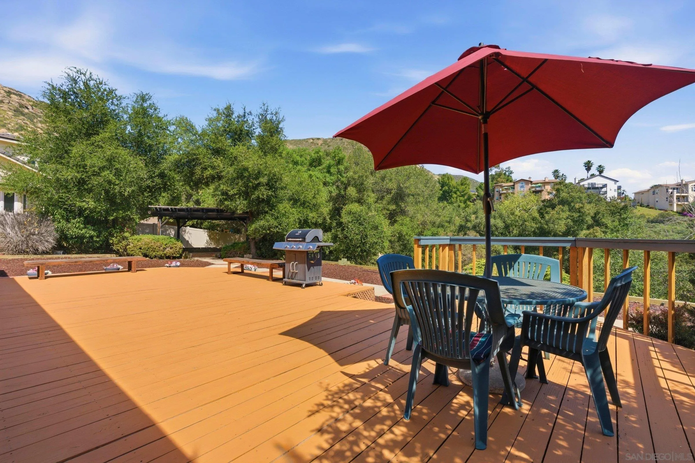 15927 Litten Way Ramona, CA 92065 - Photo 23 of 33 a view of a roof deck with table and chairs under an umbrella