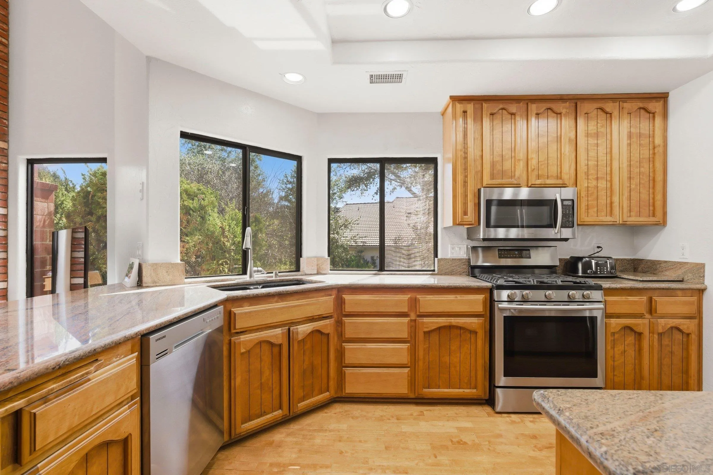 15927 Litten Way Ramona, CA 92065 - Photo 6 of 33 a kitchen with a stove a sink and a microwave