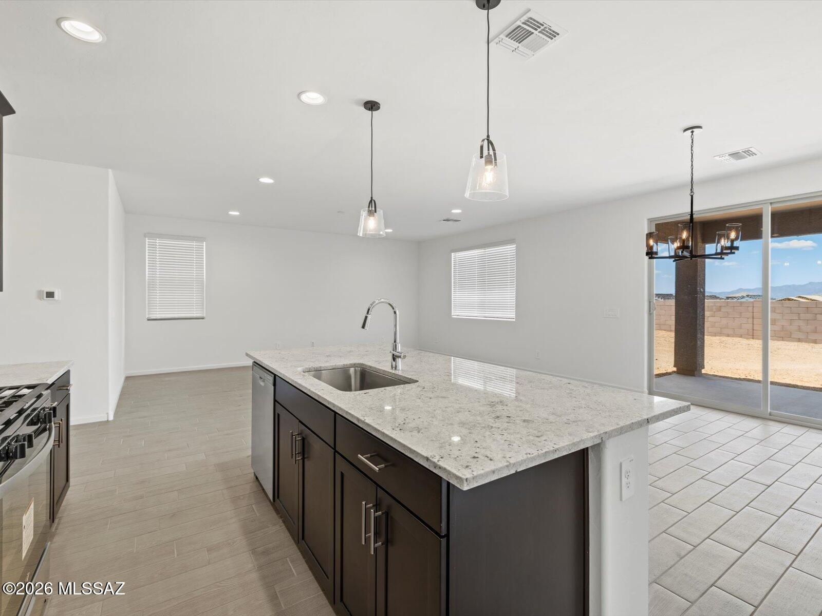 5133 West Gainer Ridge Road Tucson, AZ 85757 - Photo 15 of 16 a kitchen with center island sink and refrigerator