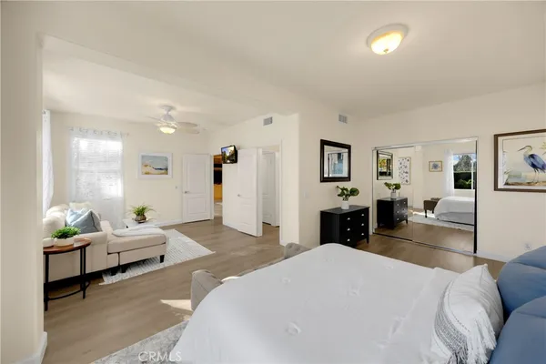a bedroom with a bed and wooden floor