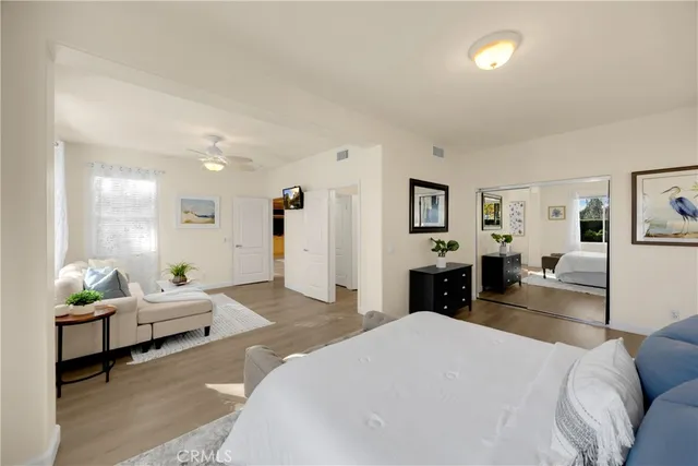 a bedroom with a bed and wooden floor