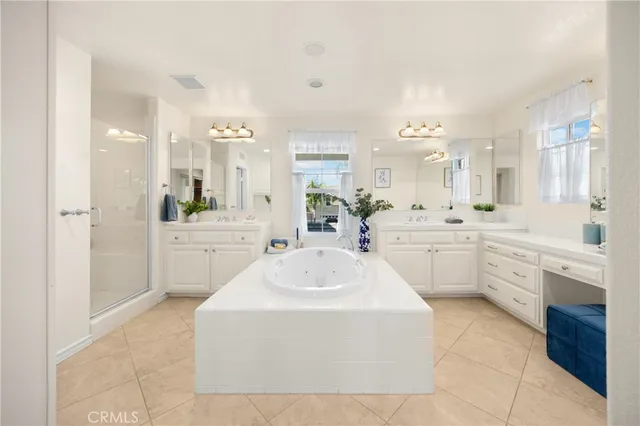 a large white bathroom with a sink a washer and dryer