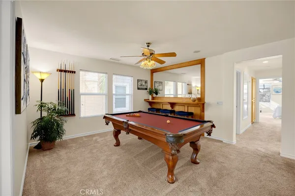 a room with furniture pool table and windows