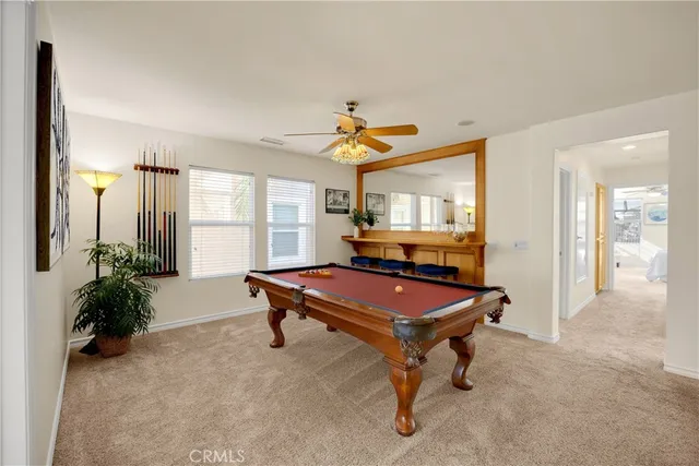 a room with furniture pool table and windows