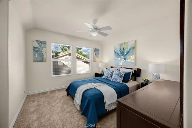 a bedroom with two beds and a window