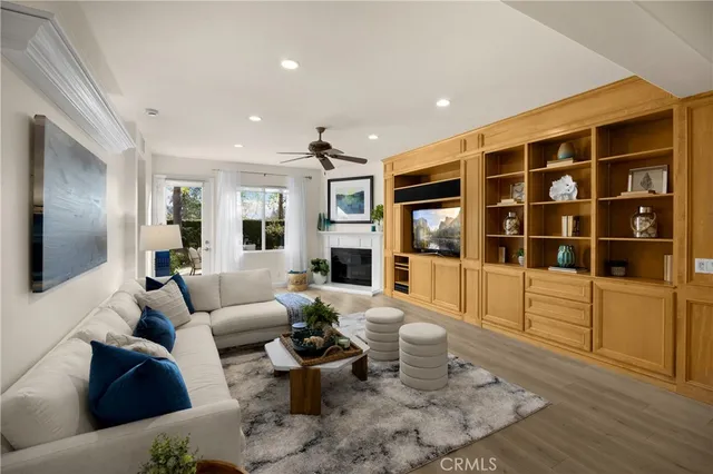 a living room with furniture and a kitchen view