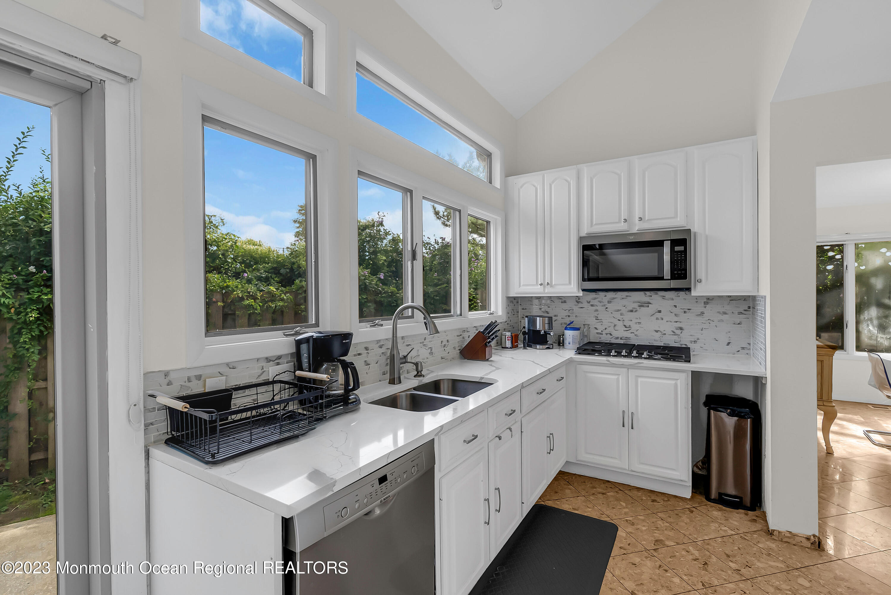 700 Ocean Avenue, Unit 9 Long Branch, NJ 07740 - Photo 11 of 35 a kitchen with a sink stove top oven and cabinets
