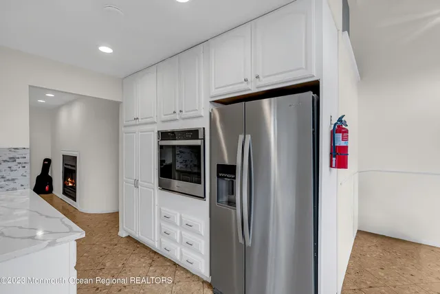 a kitchen with stainless steel appliances a refrigerator and a stove top oven