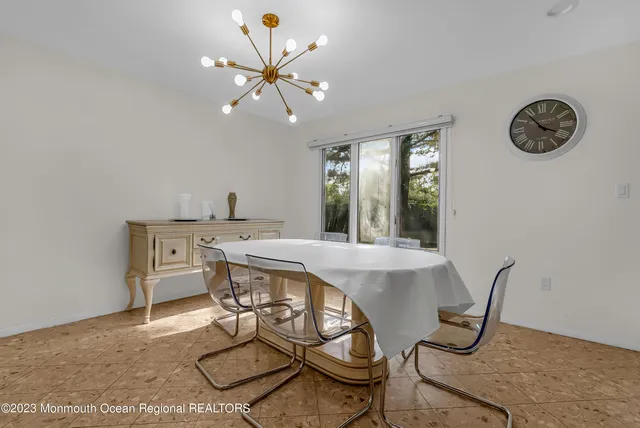 a view of a dining room with furniture and a chandelier