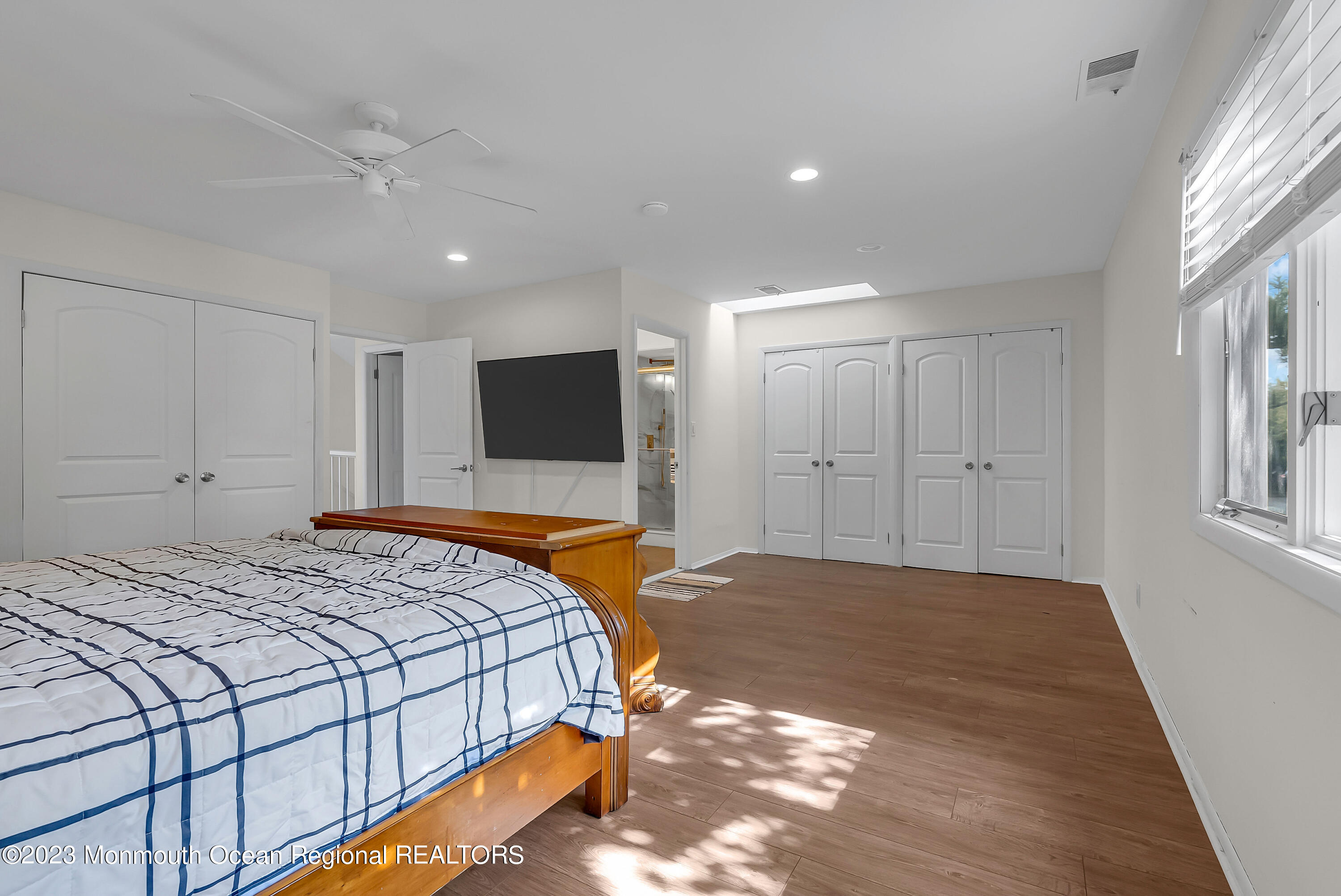 700 Ocean Avenue, Unit 9 Long Branch, NJ 07740 - Photo 20 of 35 a spacious bedroom with a bed and a flat screen tv