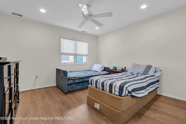 a bedroom with two beds and a chandelier