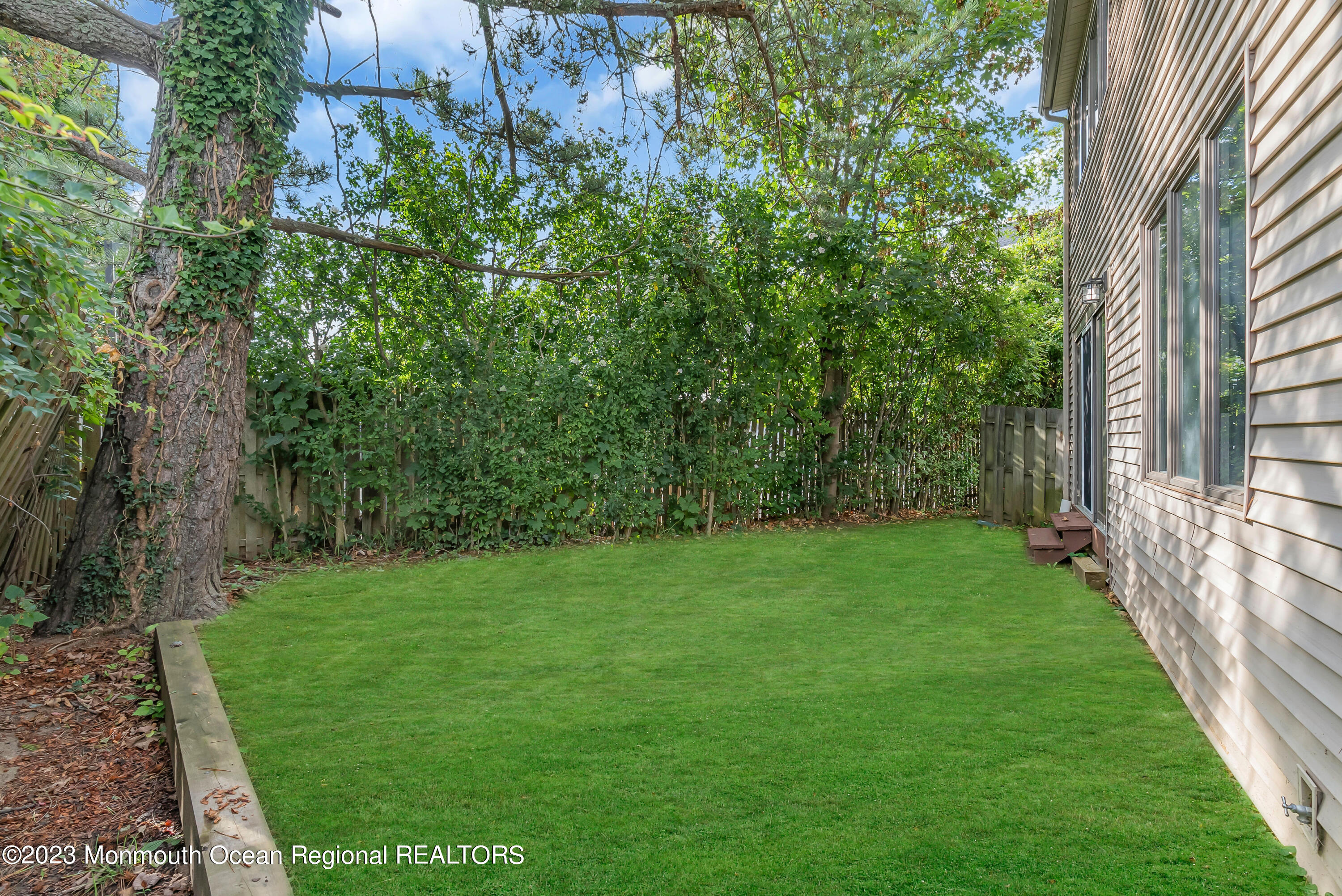 700 Ocean Avenue, Unit 9 Long Branch, NJ 07740 - Photo 35 of 35 a view of a yard with plants and a bench