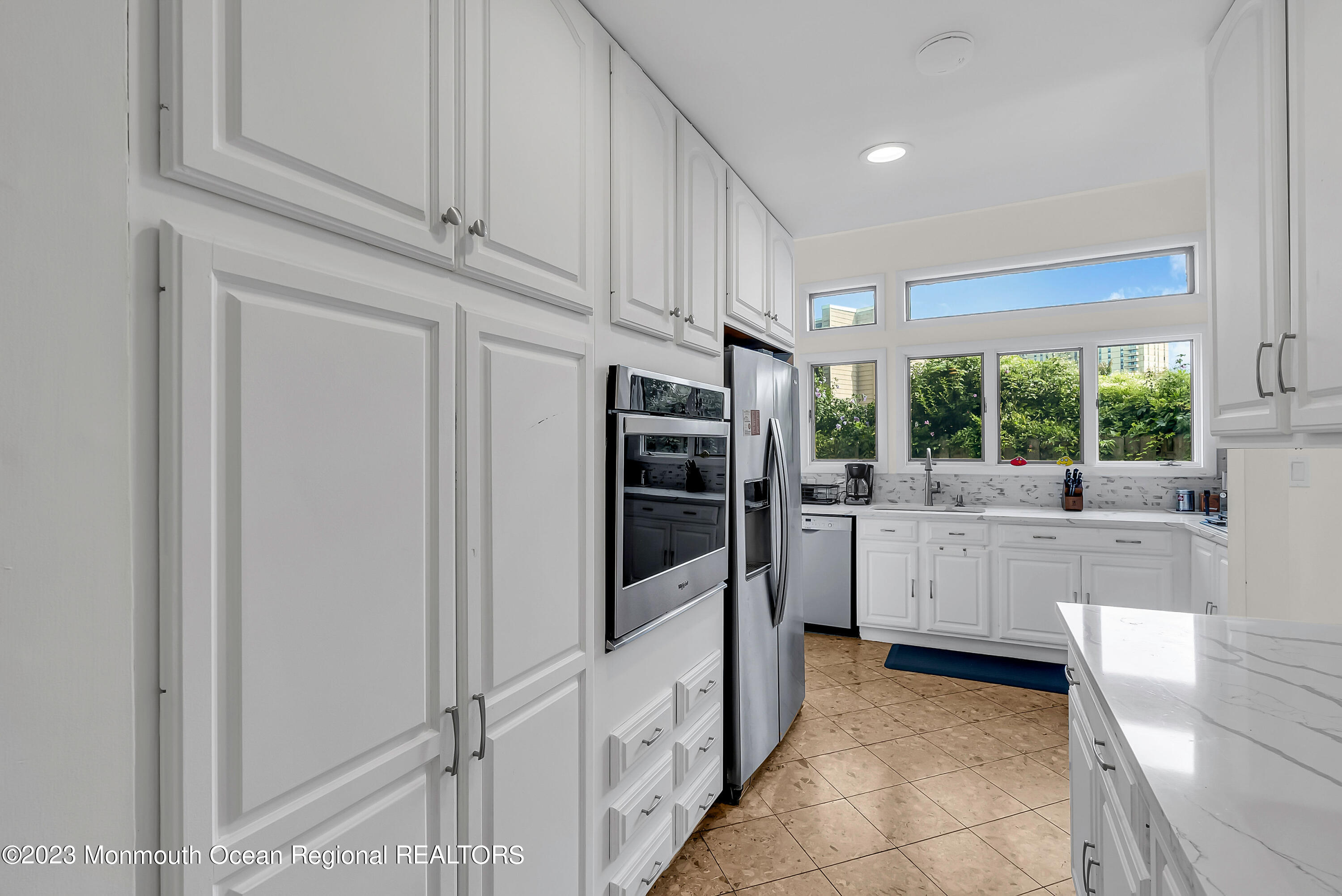700 Ocean Avenue, Unit 9 Long Branch, NJ 07740 - Photo 8 of 35 a kitchen with stainless steel appliances a refrigerator and a stove