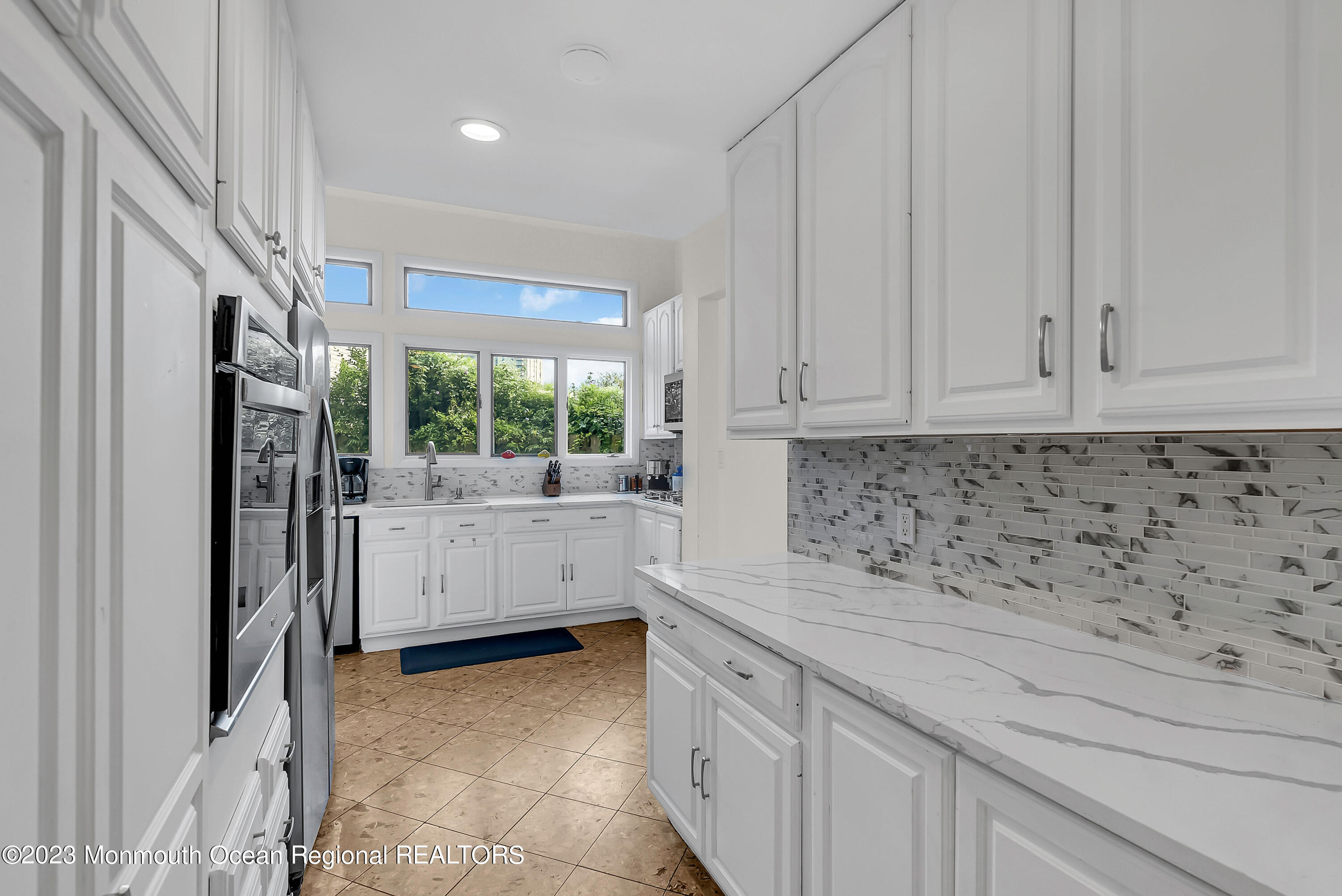 700 Ocean Avenue, Unit 9 Long Branch, NJ 07740 - Photo 9 of 35 a kitchen with white cabinets and window