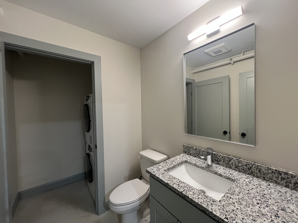 160 Seabury Street, Unit 30 Fall River, MA 02720 - Photo 12 of 13 a bathroom with a granite countertop sink toilet a mirror and shower