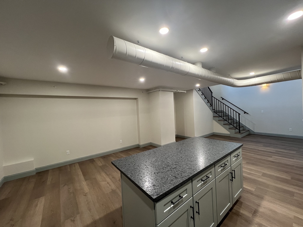 160 Seabury Street, Unit 30 Fall River, MA 02720 - Photo 2 of 13 a kitchen with stainless steel appliances granite countertop a sink a stove and a wooden floor
