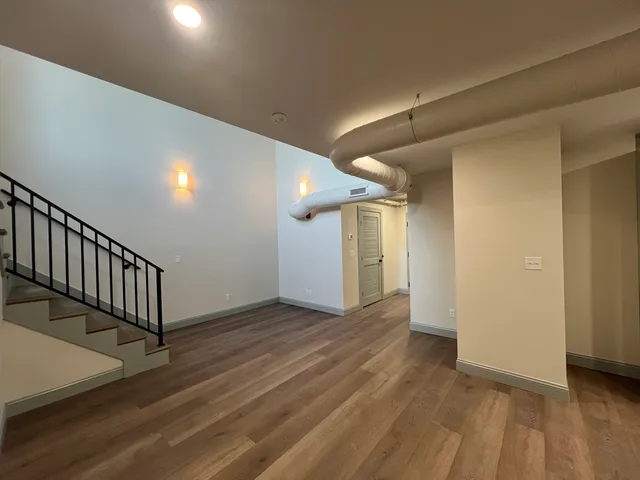 a view of a hallway with wooden floor