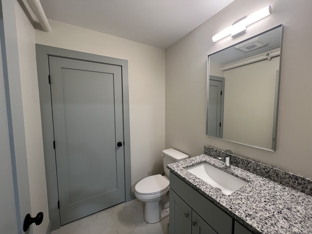 160 Seabury Street, Unit 30 Fall River, MA 02720 - Photo 5 of 13 a bathroom with a granite countertop sink toilet and shower