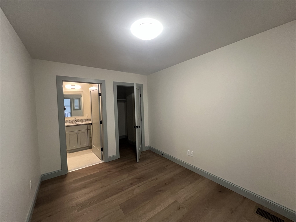 160 Seabury Street, Unit 30 Fall River, MA 02720 - Photo 9 of 13 a view of a hallway with wooden floor and a kitchen