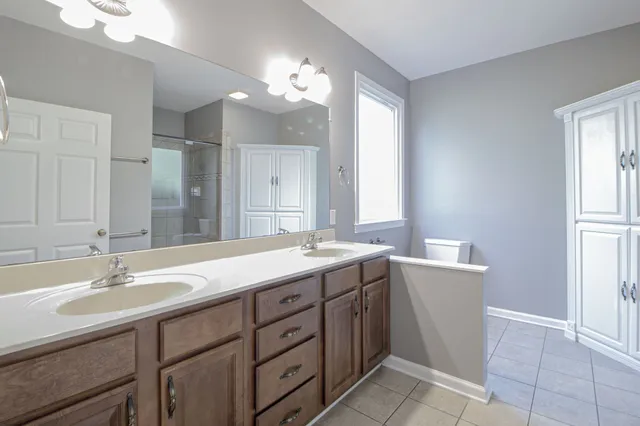 a bathroom with a sink double vanity and a mirror