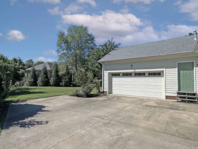 a view of a house with a yard and garage