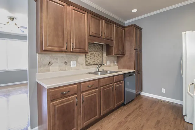 a kitchen with stainless steel appliances granite countertop a sink stove and cabinets