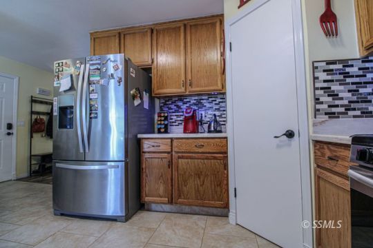 324 Sims Street Ridgecrest, CA 93555 - Photo 17 of 40 a kitchen with stainless steel appliances granite countertop a refrigerator and a stove