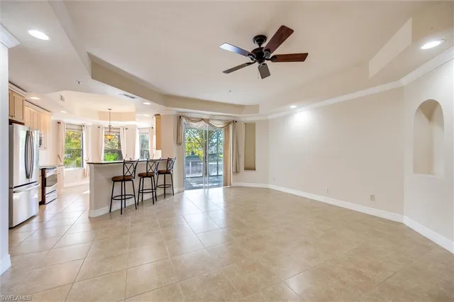 a kitchen with stainless steel appliances a refrigerator a sink and a stove with white cabinets