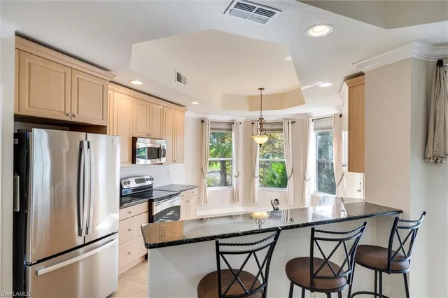 a kitchen with a sink stove and microwave