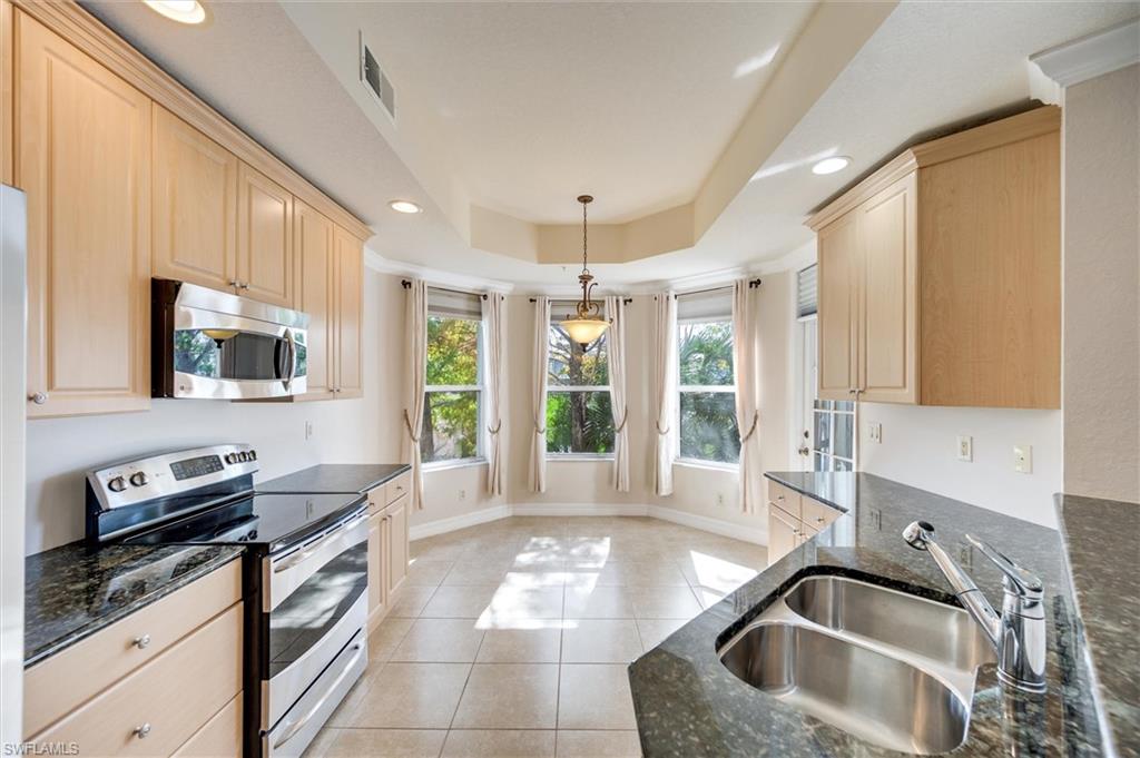 3600 Lansing Loop, Unit 103 Estero, FL 33928 - Photo 14 of 33 a kitchen with a sink stove and microwave