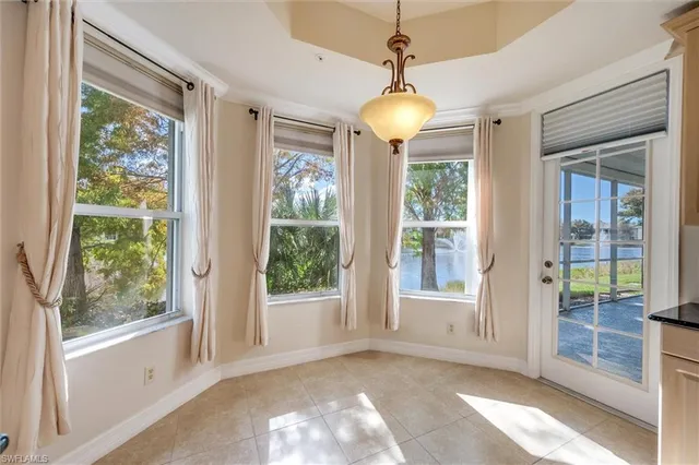 a large kitchen with granite countertop a sink and dishwasher a stove top oven with wooden floor