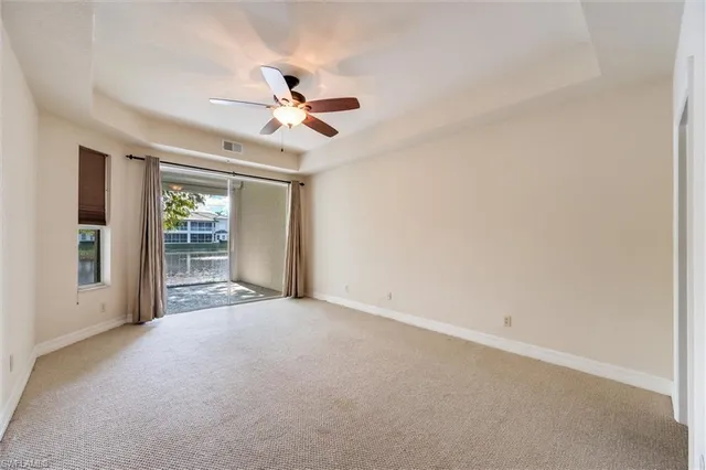 a view of a livingroom with a ceiling fan and window
