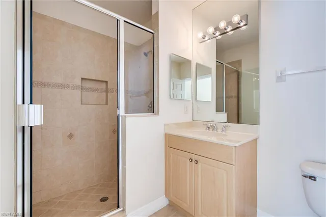 an empty room with a ceiling fan and window