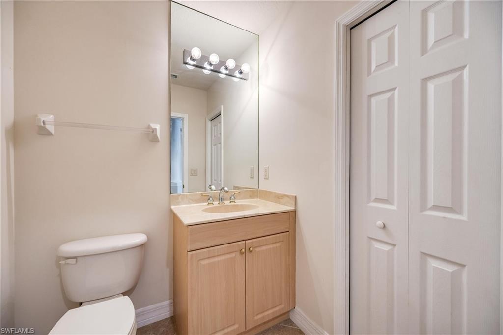 3600 Lansing Loop, Unit 103 Estero, FL 33928 - Photo 29 of 33 a bathroom with a toilet a sink and mirror