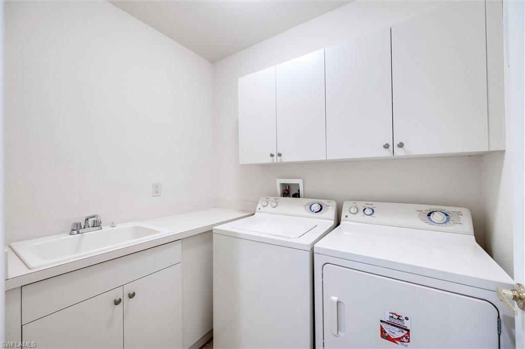3600 Lansing Loop, Unit 103 Estero, FL 33928 - Photo 30 of 33 a view of storage and utility room with washer and dryer