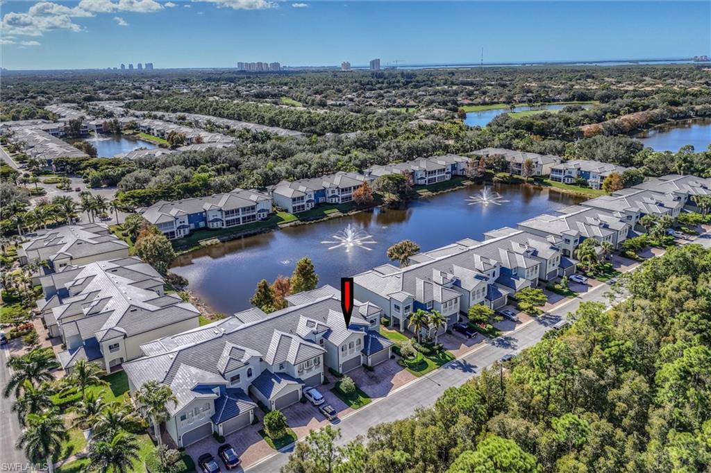 3600 Lansing Loop, Unit 103 Estero, FL 33928 - Photo 3 of 33 an aerial view of a city with lots of residential buildings ocean and mountain view in back