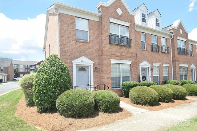 a front view of a building with a garden