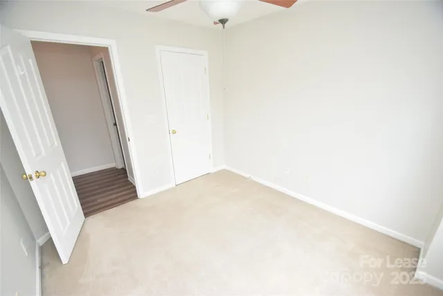 a view of hallway with stairs and wooden floor