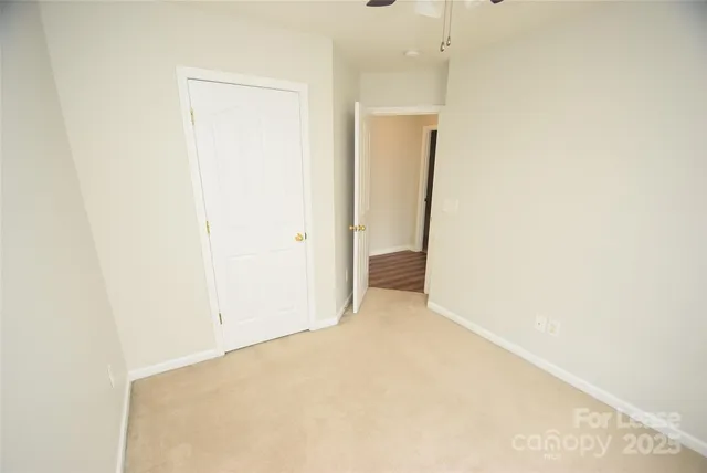 a view of staircase with white walls and a window
