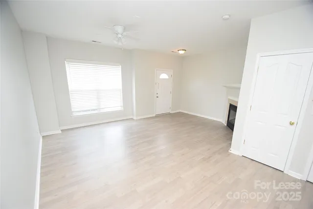 an empty room with windows and closet