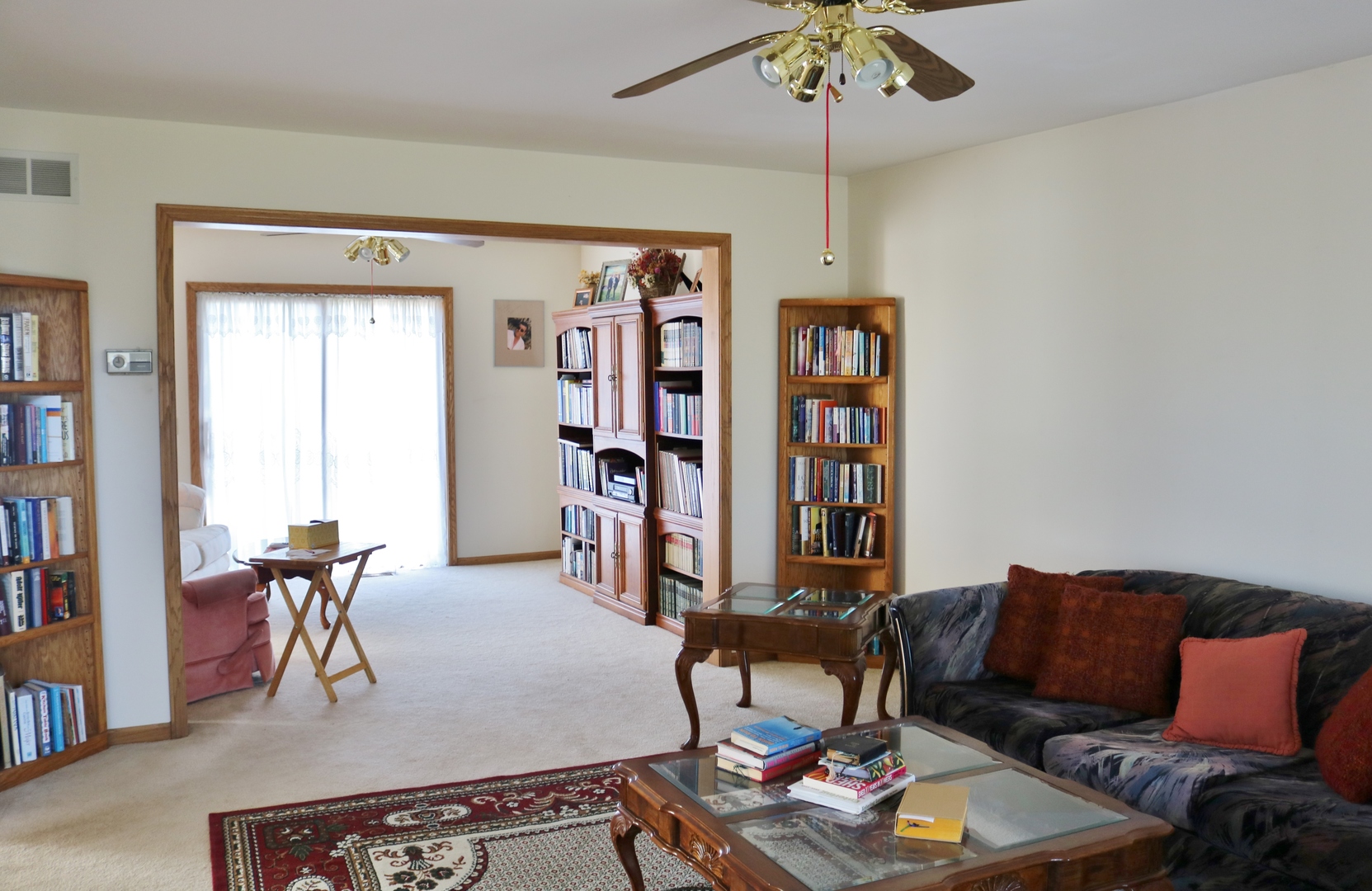 12232 Grove Road Minooka, IL 60447 - Photo 24 of 57 a living room with furniture a bookshelf and a window